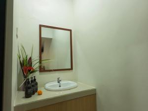 a bathroom with a sink and a mirror at JERO Tabola 2 in Sidemen