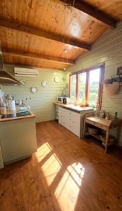 a large kitchen with wooden ceilings and a wooden floor at Amore in Chianti in Greve in Chianti +24 photos
