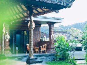 a pavilion with a table and a chair on a house at JERO Tabola 2 in Sidemen +1 photo