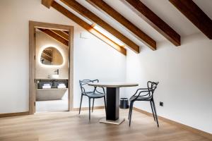 a dining room with a table and two chairs at Hotel Truita in Cangas del Narcea
