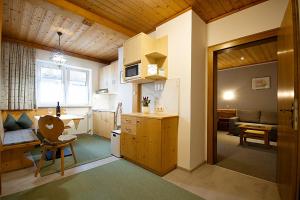 a small kitchen with a table and a dining room at Appartements Charlotte in Westendorf