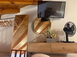 a mirror on a dresser in a room with stairs at Mersea standard apartment Kourouta in Kourouta