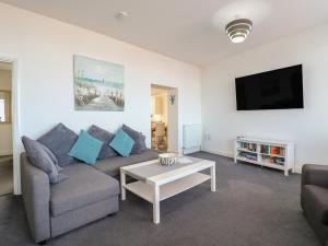 a living room with a couch and a tv at 38 The Parade in Walton-on-the-Naze