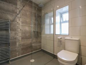 a bathroom with a toilet and a glass shower at 38 The Parade in Walton-on-the-Naze +20 photos
