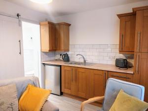 a kitchen with a sink and a counter top at Charming 1 bedroom self-contained first floor flat in Wellington