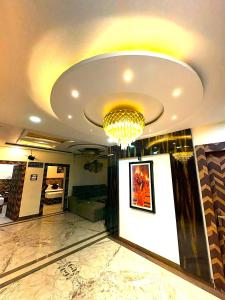 a lobby with a chandelier and a large room at Premium Hotel EXO-Near Temple and Ghat#Parking and Comfort Stay#Premium Service in Varanasi