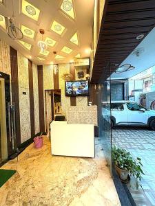 a room with a white car parked in a garage at Premium Hotel EXO-Near Temple and Ghat#Parking and Comfort Stay#Premium Service in Varanasi