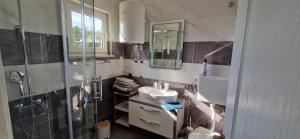a bathroom with a sink and a shower at Apartment Sanjug in Šilo +14 photos