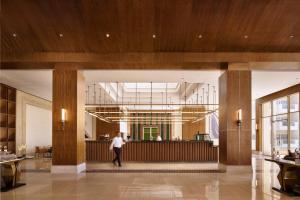 a person standing in a lobby with a bar at SRNTY Sahl Hasheesh - Ex Serenity Sky Arc in Hurghada