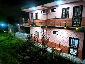 a house with a fence in front of it at night at Aasara Homestay Bhimtal Orchard Villa in Bhīm Tāl +75 photos