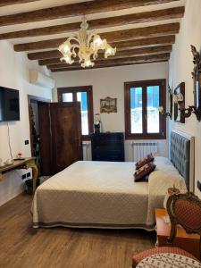a bedroom with a large bed and a chandelier at Ca' Pierre in Venice