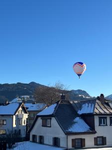 a hot air balloon in the sky over houses at Ferienwohnung Flynn in Sonthofen +56 photos