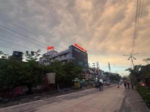 a city street with buildings and people on bikes at Hotel Skyboat Inn in Nashik