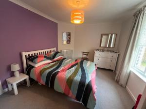 a bedroom with a bed and a dresser in it at 4 Balvaig Cottage, Strathyre in Stirling