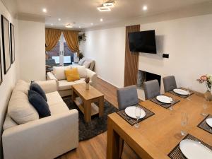 a living room with a couch and a table at Chester Charm - Spacious 3 Bedroom House in Chester