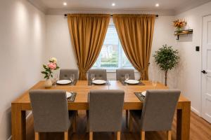 a dining room with a wooden table and chairs at Chester Charm - Spacious 3 Bedroom House in Chester