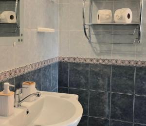 a bathroom with a sink and a toilet and towels at Bazsarózsa Apartmanok Csopak in Csopak +46 photos