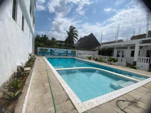 a swimming pool in the middle of a building at Tulivu Studio 2nd Floor Apartment & Great Balcony View in Watamu