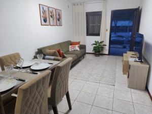 a living room with a table and a couch at casa top proximo Fenac NH in Novo Hamburgo +27 photos