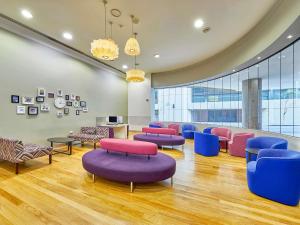 a waiting room with colorful chairs and tables at Mercure Perth in Perth