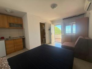 a room with a bed and a kitchen with a view at Villa Panoramic Sea View in Seoca +30 photos