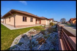 a house with a fence in front of a yard at Wellness Villa close to Prague in Kuchař