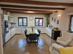 a kitchen with a table and chairs in a room at Wellness Villa close to Prague in Kuchař