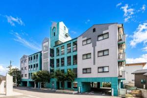 a building with a clock on the top of it at HOTEL StayLuck MARUGAME - 無料駐車場 in Marugame