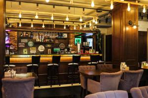 a restaurant with tables and chairs and a bar at Boomerang Boutique Hotel in Odesa
