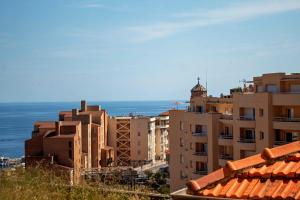 a group of buildings with the ocean in the background at My Residence d'Azur in Beausoleil