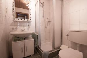 a bathroom with a sink and a toilet and a shower at Appartements Charlotte in Westendorf +39 photos