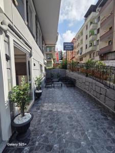 a walkway in a city with benches and buildings at Şahinler Suit Apart in Trabzon +3 photos
