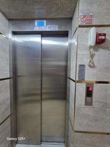 a elevator in a building with a phone on the wall at Şahinler Suit Apart in Trabzon