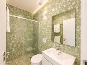 a bathroom with a toilet and a sink and a shower at Ribeira Porto by MyStay - Self Check-in Hotel in Porto