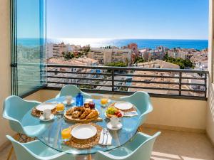 a table with food on it with a view of the ocean at Penthouse with Panoramic View Santa Pola in Santa Pola