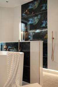 a bathroom with a black and white wall at The Walled Garden House Rooms Only Not Entire House in Mundford +28 photos