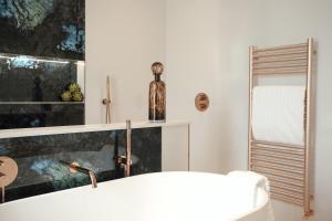 a bathroom with a sink and a bath tub at The Walled Garden House Rooms Only Not Entire House in Mundford