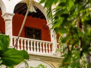 a building with a balcony with a statue on it at Sofitel Legend Santa Clara Cartagena in Cartagena de Indias