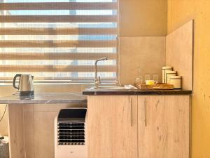 a kitchen with a sink and a window at Ring Road Guesthouse in Vereeniging +1 photo