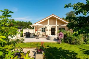 a house with a patio and a yard at Garden House 1 in Hvaler
