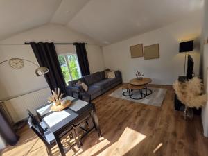 a living room with a couch and a table at Huisje 11 in Enschede