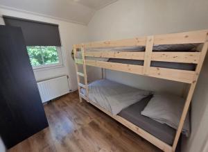 a bedroom with two bunk beds in a room at Huisje 11 in Enschede +15 photos