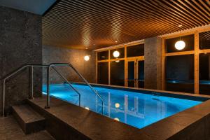 a large swimming pool in a building at Rifugio Colere 1600 by Cloud 7 in Colere