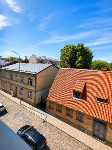 an overhead view of two buildings with red roofs at Sun Shine 1 apartment in Liepāja +17 photos