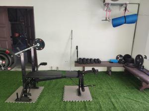 a room with a gym with a bench and weights at Pirate's Cove in Malacca