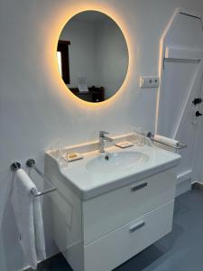 a white bathroom with a sink and a mirror at Villa Lajares Red House Fuerteventura in Lajares +64 photos