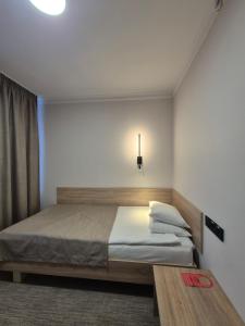 a bedroom with a bed and a table in it at Aktobe Hotel in Aktobe +142 photos