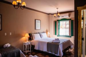 a bedroom with a bed and a window at Tiradentes Village in Tiradentes +104 photos