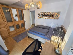 a living room with a bed and a table at Modernes Apartment mit XXL-Balkon in Hannover +12 photos