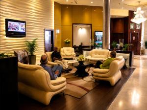 a group of people sitting in a waiting room at Tulip Creek Hotel Apartments in Dubai